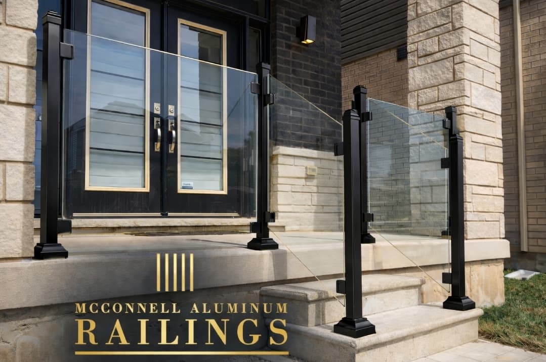 Modern glass railing with black aluminum posts on a stone porch and entryway steps.