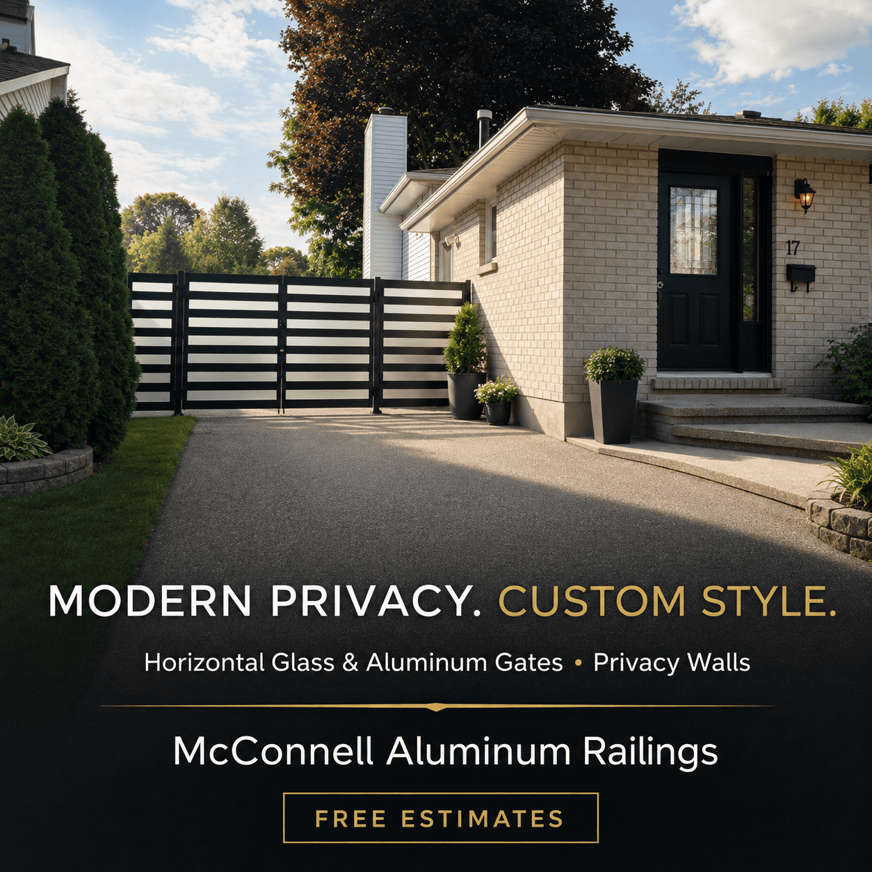 Modern black horizontal aluminum and glass privacy gate installed across a residential paved driveway.